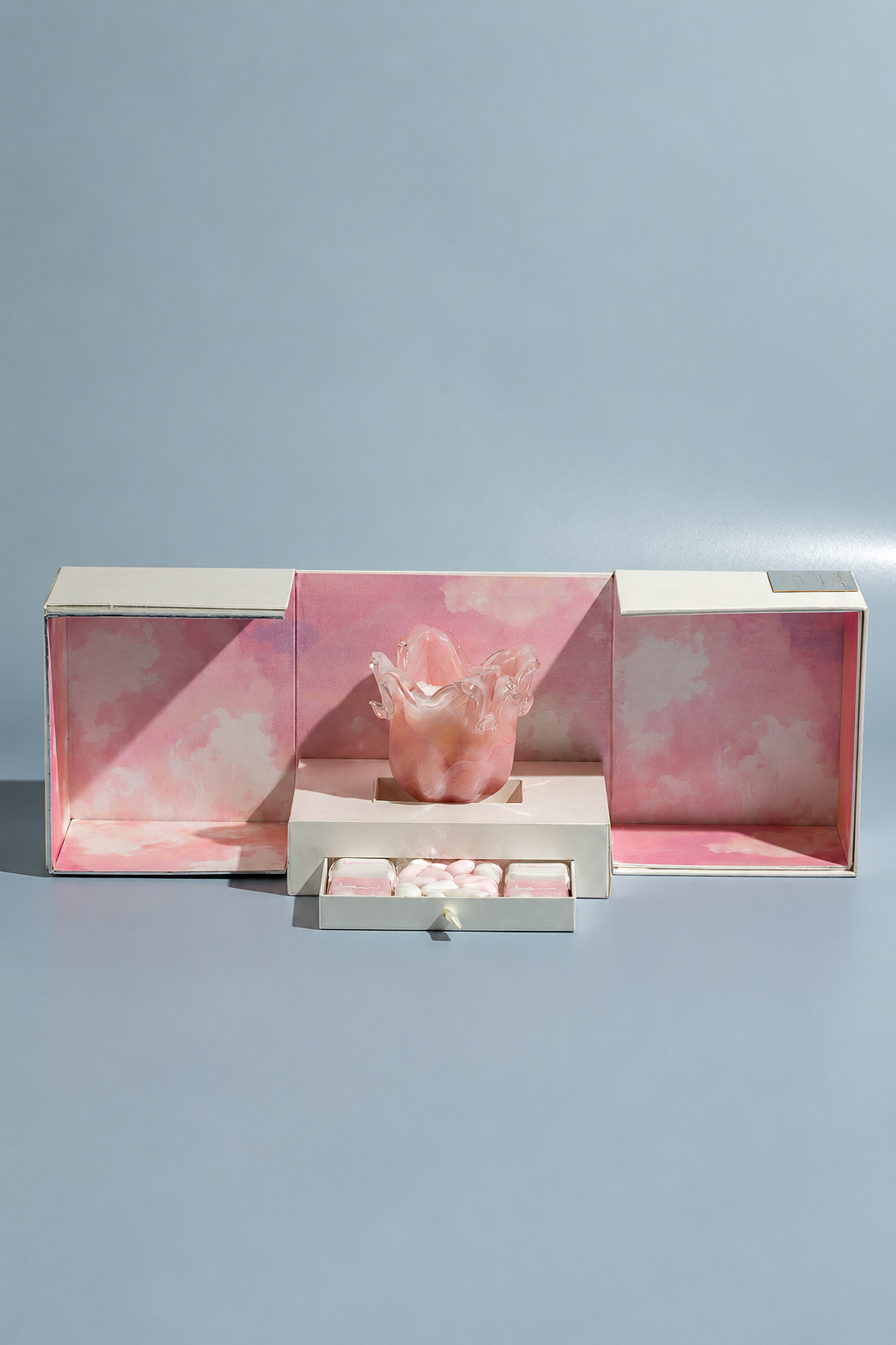 Pink presentation boxes with an open confectionery tray