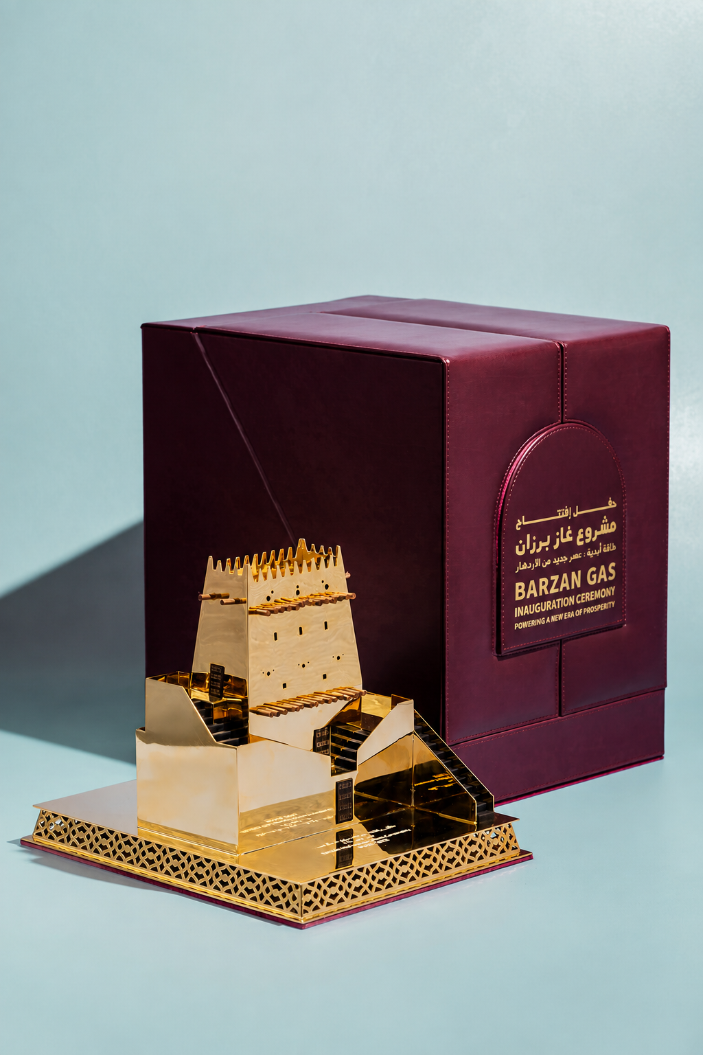Gold-toned gift display beside burgundy packaging