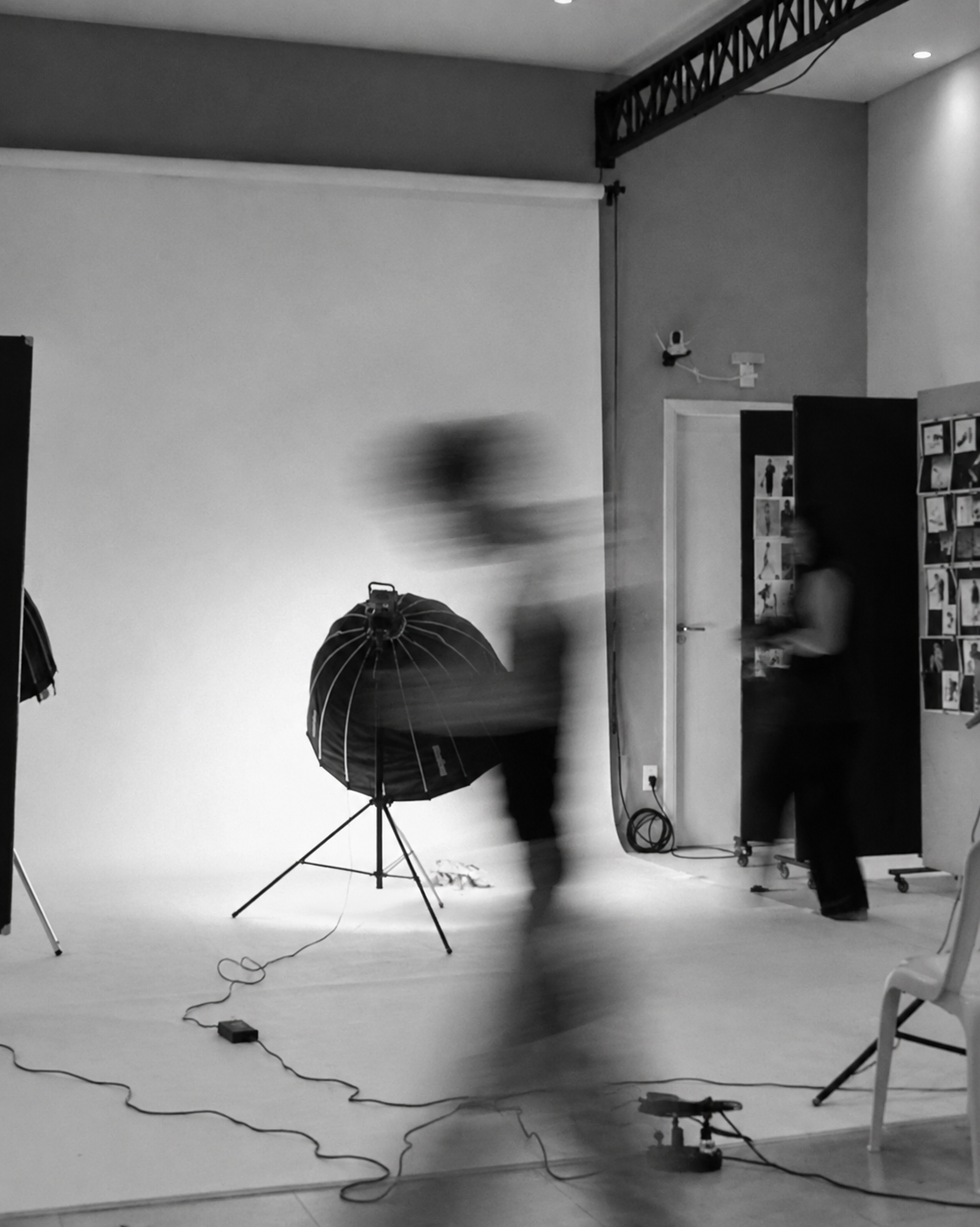 Photography studio with lighting equipment and a moving figure